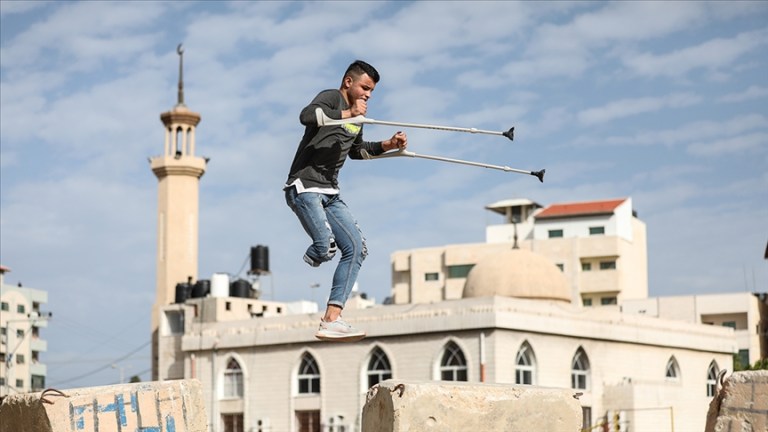 بـساق واحدة.. شاب فلسطيني يمارس “الباركور” بغزة